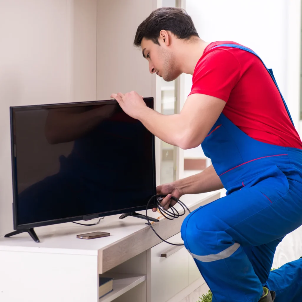 tv repair Technician servicing television at customer home